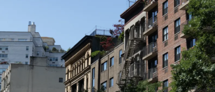 A mix of NYC residential buildings and blue sky